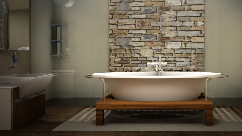 Badezimmer mit freistehender Badewanne und Mauerwerk im Hintergrund
